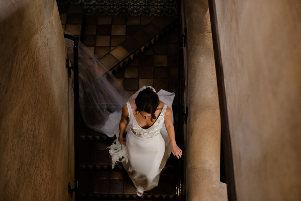 bride in gown walking down stairway in Powel Crosley