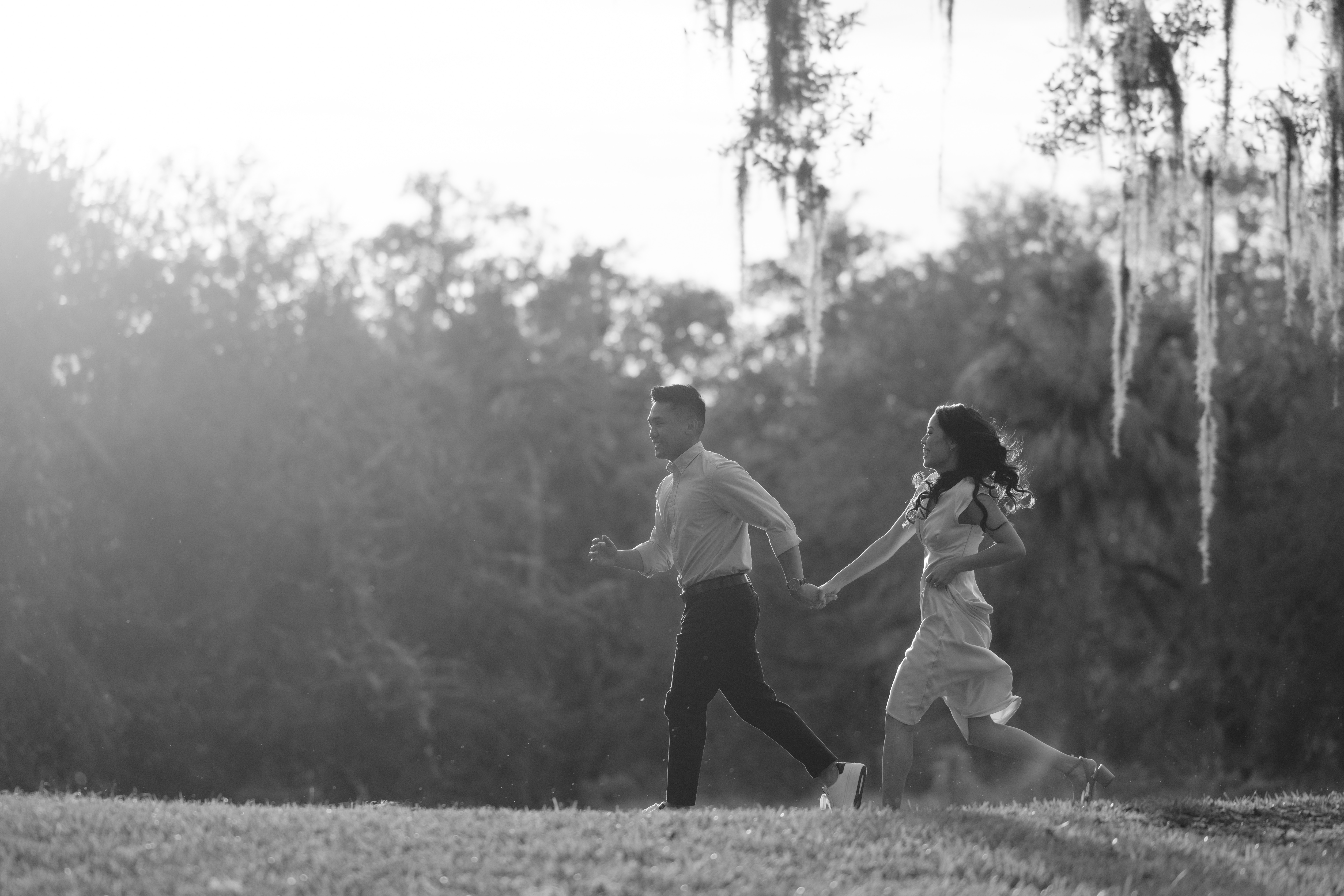 bok tower engagement session with couple running through field